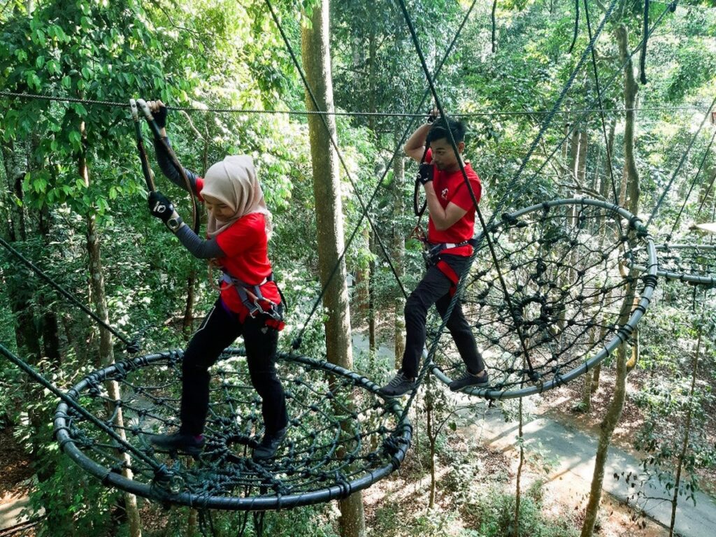 man and woman try the rope circuits at Skytrex Sungai Chongkak as one of the things to do in Selangor